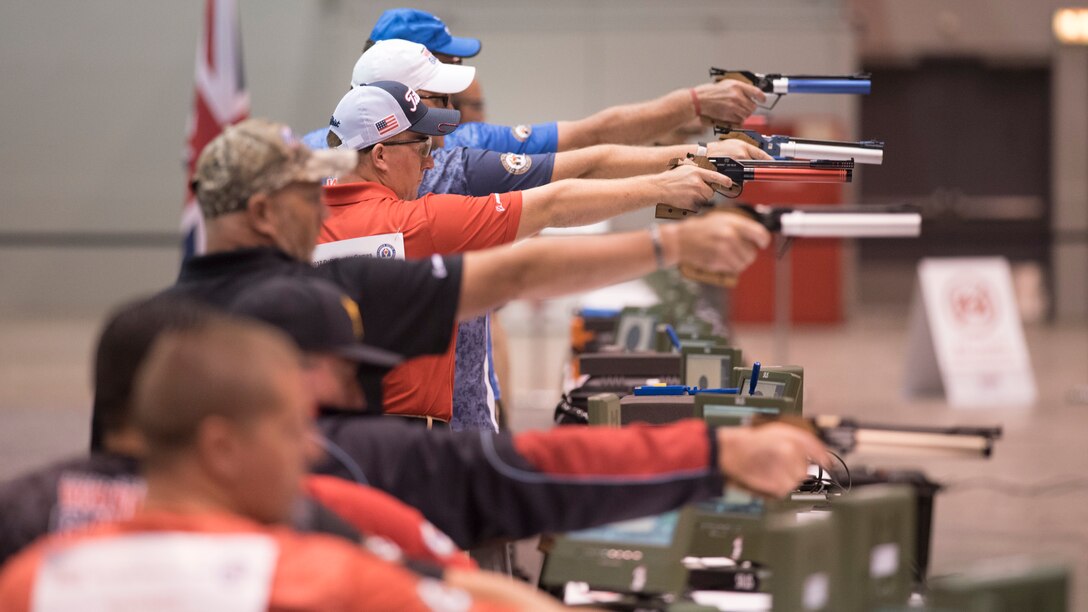 Marine Corps Sgt. Jacob H. Greenlief, center, and other athletes compete in air pistol finals during the 2017 Department of Defense Warrior Games in Chicago, July 6, 2017. Greenlief won gold in the open classification. DoD photo by Roger L. Wollenberg