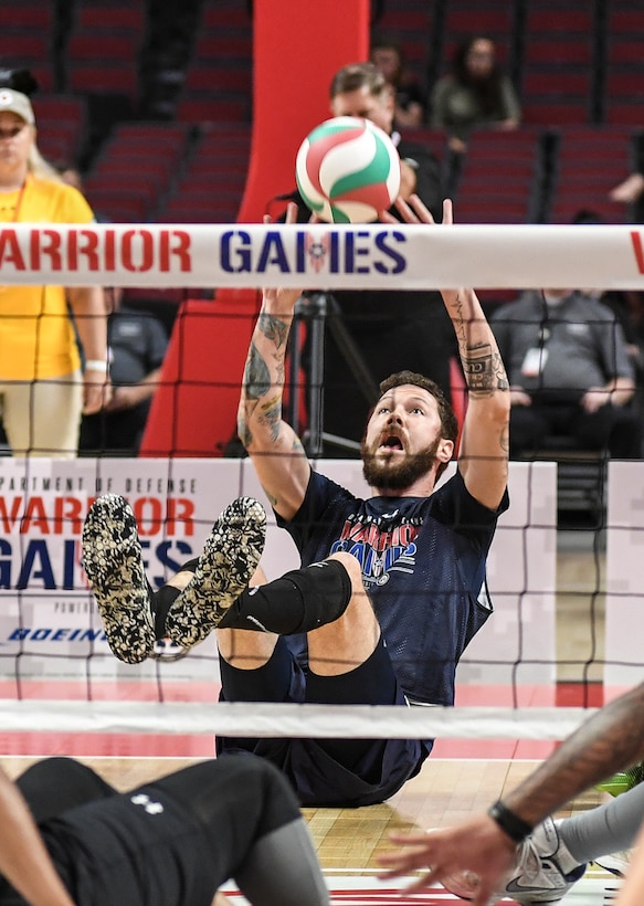 Retired Navy Petty Officer 1st Class Ryan Shannon returns the ball for Team Navy during the sitting volleyball gold medal final at the 2017 Department of Defense Warrior Games in Chicago, July 7, 2017. Navy photo by Petty Officer 2nd Class Timothy Schumaker