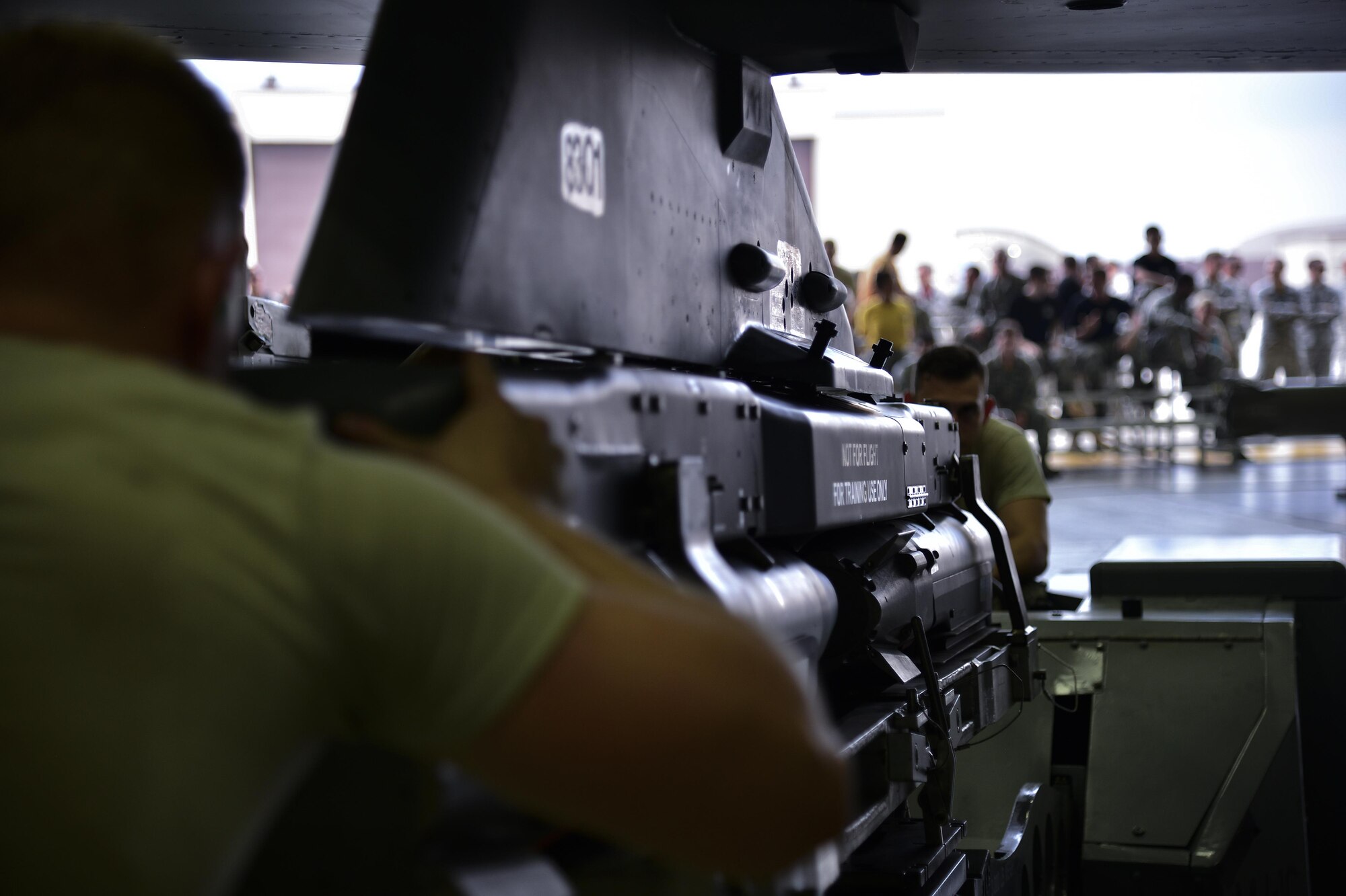 A load crew representing the 36th Aircraft Maintenance Unit loads a missile onto an F-16 Fighting Falcon during a quarterly 51st Maintenance Group weapons load competition at Osan Air Base, Republic of Korea, July 7, 2017. During the competition each team was responsible for loading an AIM-9 Sidewinder, GBU-38 Joint Direct Attack Munition and GBU-12 Paveway II onto an aircraft frame in a timely manner. (U.S. Air Force photo by Airman 1st Class Gwendalyn Smith)