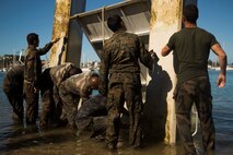 NOUMEA, NEW CALEDONIA— Marines with 3rd Battalion, 4th Marine Regiment, currently deployed to Koa Moana 17, and French army soldiers clean a piece of an obstacle course after participating in the French Nautical Commando Course during exercise Koa Moana 17, July 3, 2017, in Noumea, New Caledonia. Koa Moana 17 is designed to improve theater security, and conduct law enforcement and infantry training in the Pacific region in order to enhance interoperability with partner nations. (U.S. Marine Corps Photo by Sgt. Douglas D. Simons)