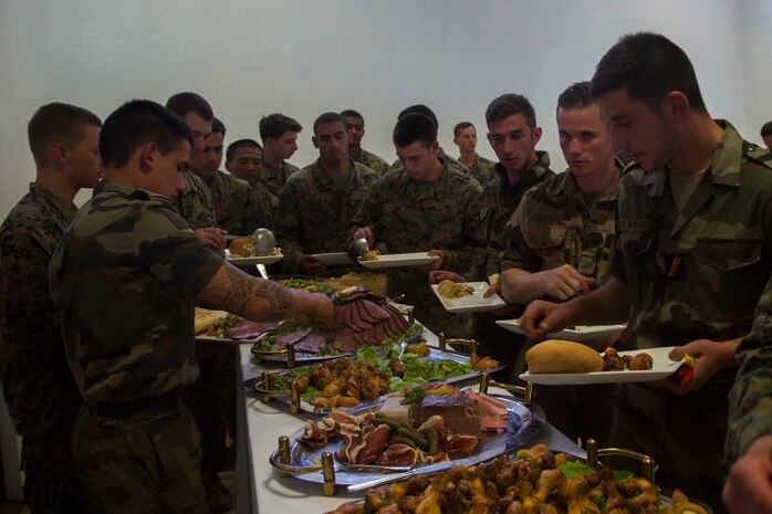 Marines and Sailors with 3rd Battalion, 4th Marine Regiment, currently deployed to Koa Moana 17, and French army soldiers grab food after participating in the French Nautical Commando Course during exercise Koa Moana 17, June 3, 2017, in Noumea, New Caledonia. Koa Moana 17 is designed to improve theater security, and conduct law enforcement and infantry training in the Pacific region in order to enhance interoperability with partner nations. (U.S. Marine Corps Photo by Sgt. Douglas D. Simons)