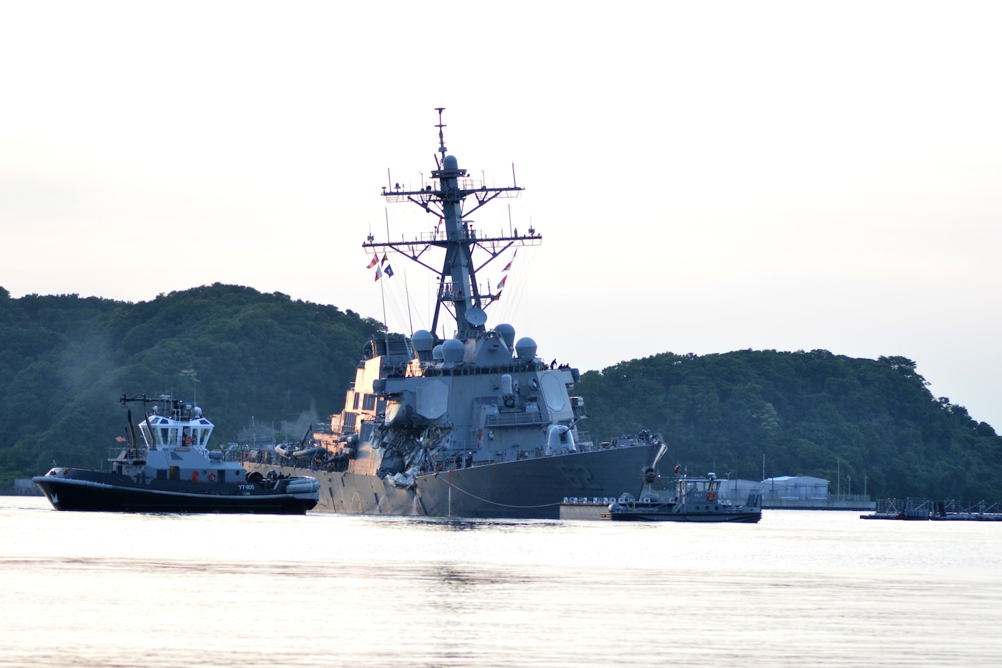 The U.S. Navy Arleigh Burke-class guided-missile destroyer USS Fitzgerald (DDG 62) returns to Fleet Activities Yokosuka following a collision with a merchant vessel while operating southwest of Yokosuka, Japan, June 17, 2017. 