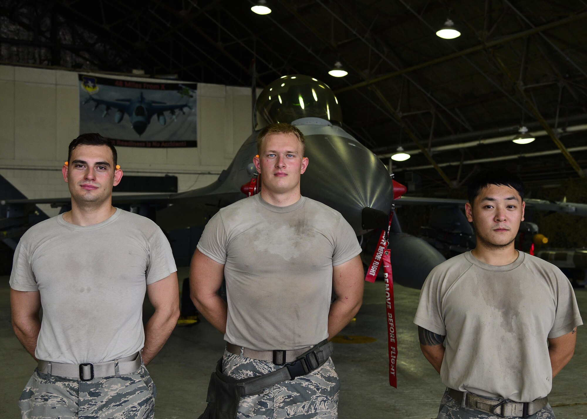 U.S. Air Force Staff Sgt. Sung Kim, Airman 1st Class Daniel Namowicz and Senior Airman Ventsislav Ivanov, 36th Aircraft Maintenance Unit weapons load crew members, pose in front of an F-16 Fighting Falcon at Osan Air Base, Republic of Korea, July 7, 2017. Both teams were required to re-generate the aircraft back to their pre-determined combat figuration status. (U.S. Air Force photo by Airman 1st Class Gwendalyn Smith)