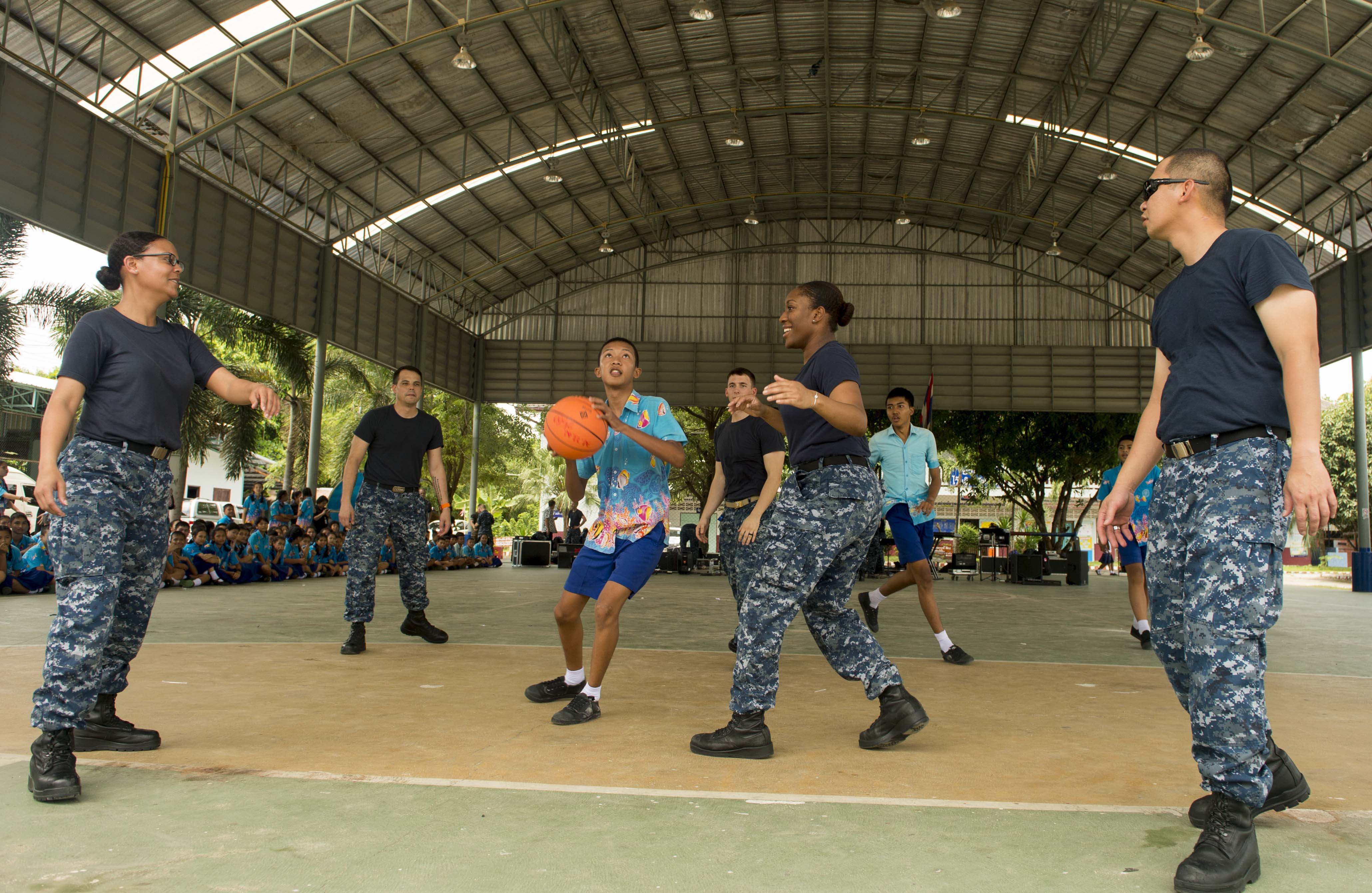 170530-N-PD309-026 PATTAYA, Thailand (May 30, 2017) Sailors assigned to littoral combat ship USS Coronado (LCS 4) play basketball with children at Ban Bang Lamung School as part of a community relations event during Cooperation Afloat Readiness and Training (CARAT) Thailand. CARAT is a series of Pacific Command-sponsored, U.S Pacific Fleet-led bilateral exercises held annually in South and Southeast Asia to strengthen relationships and enhance force readiness. CARAT exercise events cover a broad range of naval skill areas and disciplines including surface, undersea, air, and amphibious warfare; maritime security operations; riverine, jungle, and explosive ordnance disposal operations; combat construction; diving and salvage; search and rescue; maritime patrol and reconnaissance aviation; maritime domain awareness; military law, public affairs and military medicine; and humanitarian assistance and disaster response. (U.S. Navy photo by Mass Communication Specialist 3rd Class Deven Leigh Ellis/Released)