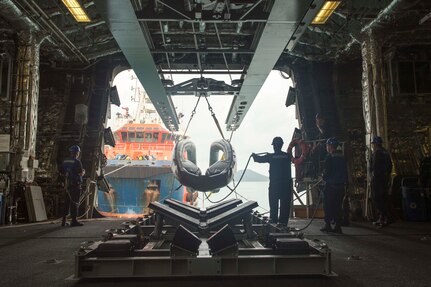 170530-N-PD309-044 SATTAHIP NAVAL BASE, Thailand (May 31, 2017) Sailors aboard littoral combat ship USS Coronado (LCS 4) use the twin-boom extensible crane to lower an 11-meter rigid-hull inflatable boat into the water for visit, board, search and seizure training during Cooperation Afloat Readiness and Training (CARAT) Thailand. CARAT is a series of Pacific Command-sponsored, U.S Pacific Fleet-led bilateral exercises held annually in South and Southeast Asia to strengthen relationships and enhance force readiness. CARAT exercise events cover a broad range of naval skill areas and disciplines including surface, undersea, air, and amphibious warfare; maritime security operations; riverine, jungle, and explosive ordnance disposal operations; combat construction; diving and salvage; search and rescue; maritime patrol and reconnaissance aviation; maritime domain awareness; military law, public affairs and military medicine; and humanitarian assistance and disaster response. (U.S. Navy photo by Mass Communication Specialist 3rd Class Deven Leigh Ellis/Released)