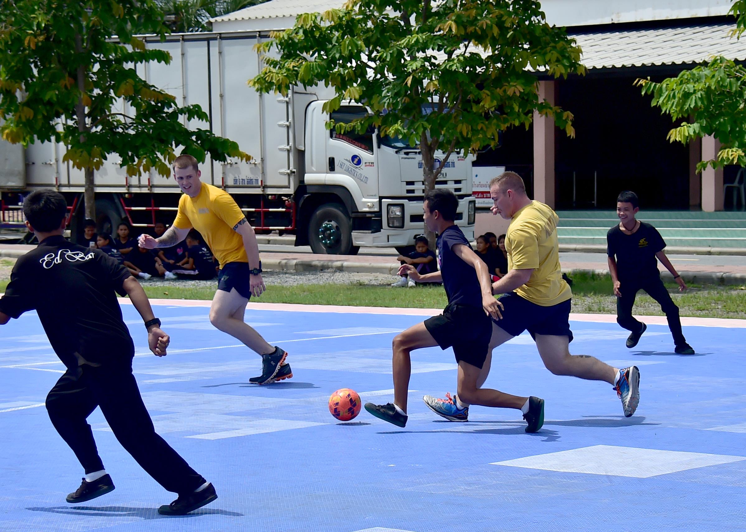 170531-N-QV906-212 PATTAYA, Thailand (May 31, 2017) Capt. Alexis Walker, Deputy Commander, Destroyer Squadron 7, raises a school child onto his shoulders from Banntunggard School during a community outreach event as part of Cooperation Afloat Readiness and Training Thailand 2017 May 31.  Cooperation Afloat Readiness and Training (CARAT) is a series of PACOM sponsored, U.S. Pacific Fleet led bilateral exercises held annually in South and Southeast Asia to strengthen relationships and enhance force readiness. CARAT exercise events cover a broad range of naval skill areas and disciplines including surface, undersea, air and amphibious warfare; maritime security operations; riverine, jungle and explosive ordnance disposal operations; combat construction; diving and salvage; search and rescue; maritime patrol and reconnaissance aviation; maritime domain awareness; military law, public affairs and military medicine; and humanitarian assistance, disaster response. (U.S. Navy photo by Mass Communication Specialist 1st Class Micah Blechner/RELEASED)