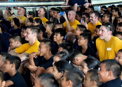 170531-N-QV906-485 PATTAYA, Thailand (May 31, 2017) Sailors attached to USS Coronado (LCS 4) watch a performance of the  U.S. 7th Fleet Band, Orient Express, with children from Banntunggard School during a community outreach event as part of Cooperation Afloat Readiness and Training Thailand 2017 May 31.  Cooperation Afloat Readiness and Training (CARAT) is a series of PACOM sponsored, U.S. Pacific Fleet led bilateral exercises held annually in South and Southeast Asia to strengthen relationships and enhance force readiness. CARAT exercise events cover a broad range of naval skill areas and disciplines including surface, undersea, air and amphibious warfare; maritime security operations; riverine, jungle and explosive ordnance disposal operations; combat construction; diving and salvage; search and rescue; maritime patrol and reconnaissance aviation; maritime domain awareness; military law, public affairs and military medicine; and humanitarian assistance, disaster response. (U.S. Navy photo by Mass Communication Specialist 1st Class Micah Blechner/RELEASED)