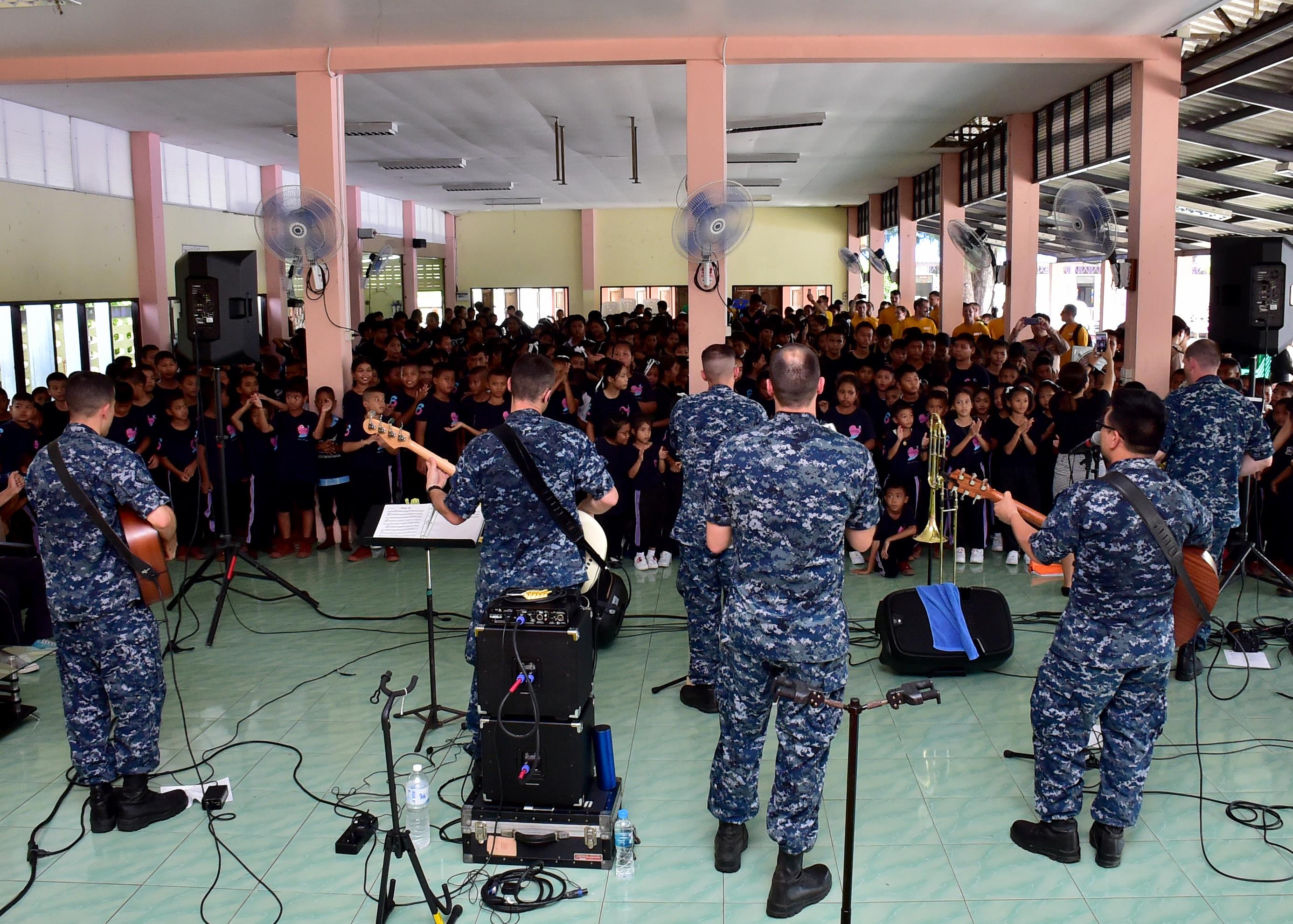 170531-N-QV906-498 PATTAYA, Thailand (May 31, 2017) The U.S. 7th Fleet Band, Orient Express, perform for children from Banntunggard School during a community outreach event as part of Cooperation Afloat Readiness and Training Thailand 2017 May 31.  Cooperation Afloat Readiness and Training (CARAT) is a series of PACOM sponsored, U.S. Pacific Fleet led bilateral exercises held annually in South and Southeast Asia to strengthen relationships and enhance force readiness. CARAT exercise events cover a broad range of naval skill areas and disciplines including surface, undersea, air and amphibious warfare; maritime security operations; riverine, jungle and explosive ordnance disposal operations; combat construction; diving and salvage; search and rescue; maritime patrol and reconnaissance aviation; maritime domain awareness; military law, public affairs and military medicine; and humanitarian assistance, disaster response. (U.S. Navy photo by Mass Communication Specialist 1st Class Micah Blechner/RELEASED)