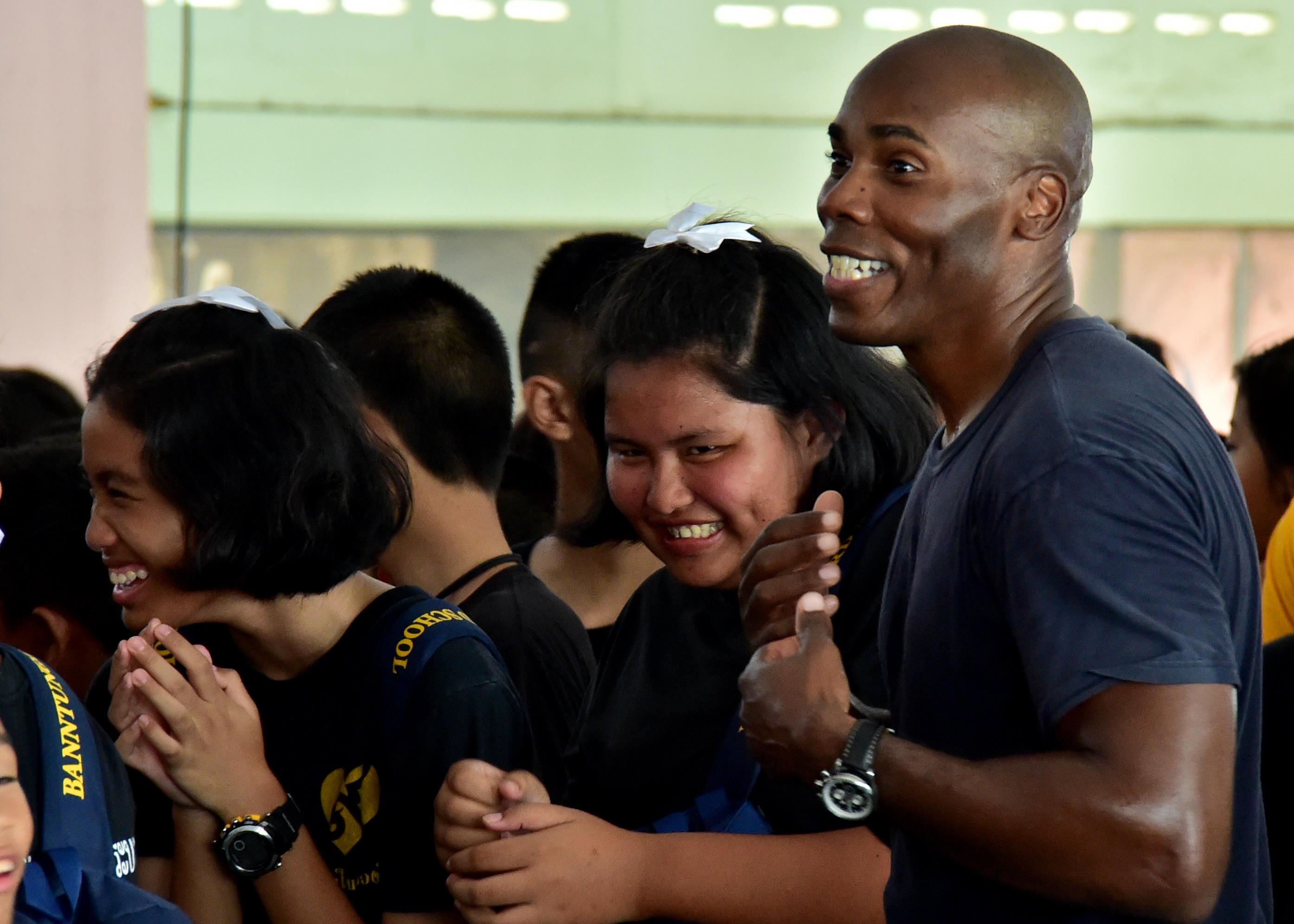 170531-N-QV906-507 PATTAYA, Thailand (May 31, 2017) Capt. Alexis Walker, Deputy Commander, Destroyer Squadron 7, dances with children from Banntunggard School during a performance of the U.S. 7th Fleet Band, Orient Express, while participating in a community outreach event as part of Cooperation Afloat Readiness and Training Thailand 2017 May 31.  Cooperation Afloat Readiness and Training (CARAT) is a series of PACOM sponsored, U.S. Pacific Fleet led bilateral exercises held annually in South and Southeast Asia to strengthen relationships and enhance force readiness. CARAT exercise events cover a broad range of naval skill areas and disciplines including surface, undersea, air and amphibious warfare; maritime security operations; riverine, jungle and explosive ordnance disposal operations; combat construction; diving and salvage; search and rescue; maritime patrol and reconnaissance aviation; maritime domain awareness; military law, public affairs and military medicine; and humanitarian assistance, disaster response. (U.S. Navy photo by Mass Communication Specialist 1st Class Micah Blechner/RELEASED)