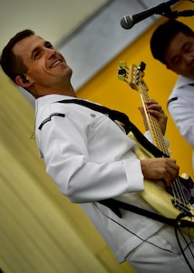 170602-N-QV906-034 PATTAYA, Thailand (June 2, 2017) Navy Musician 2nd Class Mark Lame, of the U.S. 7th Fleet Band, Orient Express, jams out during a performance at Pattaya City No. 8 School as part of Cooperation Afloat Readiness and Training Thailand 2017 in Pattaya, Thailand, June 2. Cooperation Afloat Readiness and Training (CARAT) is a series of PACOM sponsored, U.S. Pacific Fleet led bilateral exercises held annually in South and Southeast Asia to strengthen relationships and enhance force readiness. CARAT exercise events cover a broad range of naval skill areas and disciplines including surface, undersea, air and amphibious warfare; maritime security operations; riverine, jungle and explosive ordnance disposal operations; combat construction; diving and salvage; search and rescue; maritime patrol and reconnaissance aviation; maritime domain awareness; military law, public affairs and military medicine; and humanitarian assistance, disaster response. (U.S. Navy photo by Mass Communication Specialist 1st Class Micah Blechner/RELEASED)