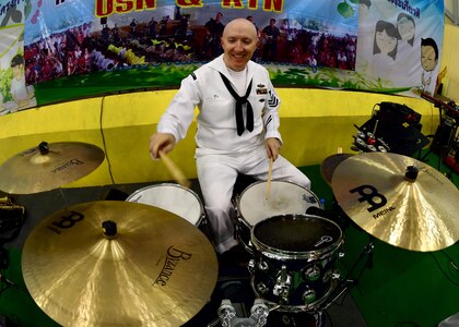 170602-N-QV906-054 PATTAYA, Thailand (June 2, 2017) Navy Musician 1st Class Stephen Hux, of the U.S. 7th Fleet Band, Orient Express, jams
out during a performance at Pattaya City No. 8 School as part of Cooperation Afloat Readiness and Training Thailand 2017 in Pattaya,
Thailand, June 2. Cooperation Afloat Readiness and Training (CARAT) is a series of PACOM sponsored, U.S. Pacific Fleet led bilateral
exercises held annually in South and Southeast Asia to strengthen relationships and enhance force readiness. CARAT exercise events cover
a broad range of naval skill areas and disciplines including surface, undersea, air and amphibious warfare; maritime security operations;
riverine, jungle and explosive ordnance disposal operations; combat construction; diving and salvage; search and rescue; maritime patrol
and reconnaissance aviation; maritime domain awareness; military law, public affairs and military medicine; and humanitarian assistance,
disaster response. (U.S. Navy photo by Mass Communication Specialist 1st Class Micah Blechner/RELEASED)