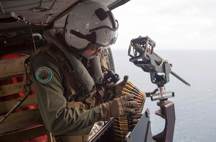170603-N-PD309-786 GULF OF THAILAND (June 3, 2017) Naval Aircrewman (Helicopter) 2nd Class Nicholas Lovelace, assigned to the "Wildcards" of Helicopter Sea Combat Squadron 23 aboard littoral combat ship USS Coronado (LCS 4), loads rounds into a .50 caliber machine gun before a gunnery exercise with the Royal Thai Navy during Cooperation Afloat Readiness and Training (CARAT) Thailand. CARAT is a series of Pacific Command-sponsored, U.S Pacific Fleet-led bilateral exercises held annually in South and Southeast Asia to strengthen relationships and enhance force readiness. CARAT exercise events cover a broad range of naval skill areas and disciplines including surface, undersea, air, and amphibious warfare; maritime security operations; riverine, jungle, and explosive ordnance disposal operations; combat construction; diving and salvage; search and rescue; maritime patrol and reconnaissance aviation; maritime domain awareness; military law, public affairs and military medicine; and humanitarian assistance and disaster response. (U.S. Navy photo by Mass Communication Specialist 3rd Class Deven Leigh Ellis/Released)