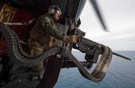 170603-N-PD309-946 GULF OF THAILAND (June 3, 2017) Naval Aircrewman (Helicopter) 2nd Class Nicholas Lovelace, assigned to the "Wildcards" of Helicopter Sea Combat Squadron 23 aboard littoral combat ship USS Coronado (LCS 4), prepares to shoot a target with a .50 caliber machine gun during a gunnery exercise with the Royal Thai Navy during Cooperation Afloat Readiness and Training (CARAT) Thailand. CARAT is a series of Pacific Command-sponsored, U.S Pacific Fleet-led bilateral exercises held annually in South and Southeast Asia to strengthen relationships and enhance force readiness. CARAT exercise events cover a broad range of naval skill areas and disciplines including surface, undersea, air, and amphibious warfare; maritime security operations; riverine, jungle, and explosive ordnance disposal operations; combat construction; diving and salvage; search and rescue; maritime patrol and reconnaissance aviation; maritime domain awareness; military law, public affairs and military medicine; and humanitarian assistance and disaster response. (U.S. Navy photo by Mass Communication Specialist 3rd Class Deven Leigh Ellis/Released)