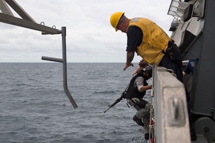 170604-N-PD309-018 GULF OF THAILAND (June 4, 2017) Boatswain's Mate 2nd Class Paul Coombs helps a Royal Thai Navy Sailor board littoral combat ship USS Coronado (LCS 4) as part of a visit, board, search and seizure exercise during Cooperation Afloat Readiness and Training (CARAT) Thailand. CARAT is a series of Pacific Command-sponsored, U.S Pacific Fleet-led bilateral exercises held annually in South and Southeast Asia to strengthen relationships and enhance force readiness. CARAT exercise events cover a broad range of naval skill areas and disciplines including surface, undersea, air, and amphibious warfare; maritime security operations; riverine, jungle, and explosive ordnance disposal operations; combat construction; diving and salvage; search and rescue; maritime patrol and reconnaissance aviation; maritime domain awareness; military law, public affairs and military medicine; and humanitarian assistance and disaster response. (U.S. Navy photo by Mass Communication Specialist 3rd Class Deven Leigh Ellis/Released)