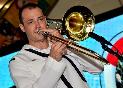 170604-N-QV906-019 PATTAYA, Thailand (June 4, 2017) Navy Musician 3rd Class Patrick Chappell, of the U.S. 7th Fleet Band, Orient Express, jams out during a performance at Golden Plaza Mall in Pattaya, Thailand, while participating in Cooperation Afloat Readiness and Training Thailand 2017 June 3.  Cooperation Afloat Readiness and Training (CARAT) is a series of PACOM sponsored, U.S. Pacific Fleet led bilateral exercises held annually in South and Southeast Asia to strengthen relationships and enhance force readiness. CARAT exercise events cover a broad range of naval skill areas and disciplines including surface, undersea, air and amphibious warfare; maritime security operations; riverine, jungle and explosive ordnance disposal operations; combat construction; diving and salvage; search and rescue; maritime patrol and reconnaissance aviation; maritime domain awareness; military law, public affairs and military medicine; and humanitarian assistance, disaster response. (U.S. Navy photo by Mass Communication Specialist 1st Class Micah Blechner/RELEASED)