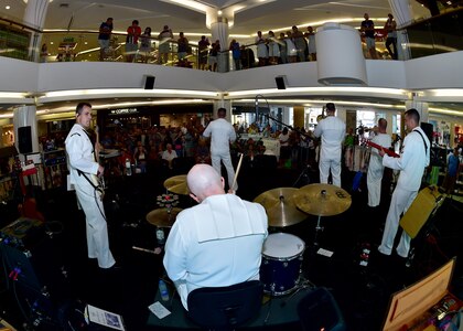 170604-N-QV906-023 PATTAYA, Thailand (June 4, 2017) , of the U.S. 7th Fleet Band, Orient Express, jams out during a performance at Golden Plaza Mall in Pattaya, Thailand, while participating in Cooperation Afloat Readiness and Training Thailand 2017 June 3.  Cooperation Afloat Readiness and Training (CARAT) is a series of PACOM sponsored, U.S. Pacific Fleet led bilateral exercises held annually in South and Southeast Asia to strengthen relationships and enhance force readiness. CARAT exercise events cover a broad range of naval skill areas and disciplines including surface, undersea, air and amphibious warfare; maritime security operations; riverine, jungle and explosive ordnance disposal operations; combat construction; diving and salvage; search and rescue; maritime patrol and reconnaissance aviation; maritime domain awareness; military law, public affairs and military medicine; and humanitarian assistance, disaster response. (U.S. Navy photo by Mass Communication Specialist 1st Class Micah Blechner/RELEASED)