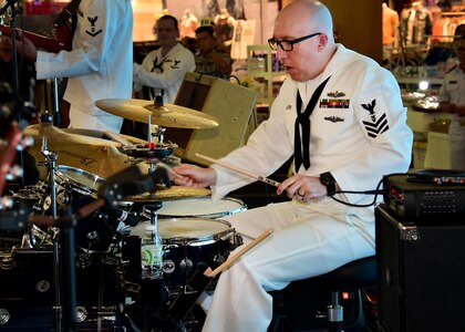 170604-N-QV906-051 PATTAYA, Thailand (June 4, 2017) Navy Musician 1st Class Stephen Hux, of the U.S. 7th Fleet Band, Orient Express, jams out during a performance at Golden Plaza Mall in Pattaya, Thailand, while participating in Cooperation Afloat Readiness and Training Thailand 2017 June 3.  Cooperation Afloat Readiness and Training (CARAT) is a series of PACOM sponsored, U.S. Pacific Fleet led bilateral exercises held annually in South and Southeast Asia to strengthen relationships and enhance force readiness. CARAT exercise events cover a broad range of naval skill areas and disciplines including surface, undersea, air and amphibious warfare; maritime security operations; riverine, jungle and explosive ordnance disposal operations; combat construction; diving and salvage; search and rescue; maritime patrol and reconnaissance aviation; maritime domain awareness; military law, public affairs and military medicine; and humanitarian assistance, disaster response. (U.S. Navy photo by Mass Communication Specialist 1st Class Micah Blechner/RELEASED)