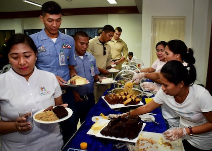 170620-N-QV906-115 CEBU, Philippines (June 20, 2017) First responders from the U.S. Navy, Armed Forces of the Philippines, and local and municipal emergency medical services eat a meal together during an interactive medical engagement for Maritime Training Activity (MTA) Sama Sama 2017 in Cebu, Philippines, June 20.  MTA Sama Sama is a bilateral maritime exercise between U.S. and Philippine naval forces and is designed to strengthen cooperation and interoperability between the nations' armed forces.  (U.S. Navy photo by Mass Communication Specialist 1st Class Micah Blechner/RELEASED)