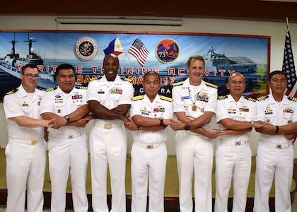 170624-N-QV906-164 CEBU, Philippines (June 24, 2016) Officers from the U.S. Navy and Armed Forces of the Philippines stand hand-in-hand during the closing ceremony of Maritime Training Activity (MTA) Sama Sama 2017 in Cebu, Philippines, June 24. (U.S. Navy photo by Mass Communication Specialist 1st Class Micah Blechner/RELEASED)