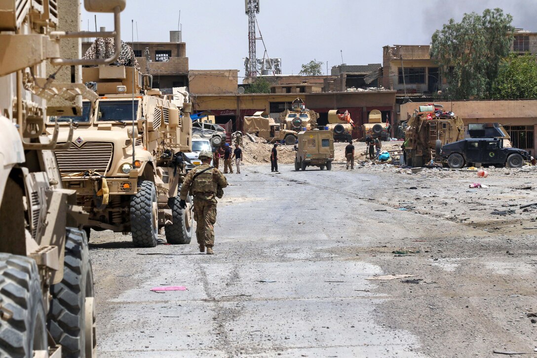 U.S. soldiers meet their Iraqi security force partners in a recently liberated neighborhood in west Mosul, Iraq, July 2, 2017. The soldiers are paratroopers assigned to the 82nd Airborne Division’s 2nd Brigade Combat Team, Combined Joint Task Force - Operation Inherent Resolve. A global Coalition of more than 70 nations and organizations have joined together to enable partner forces to defeat ISIS and restore stability and security. Army photo by Staff Sgt. Jason Hull