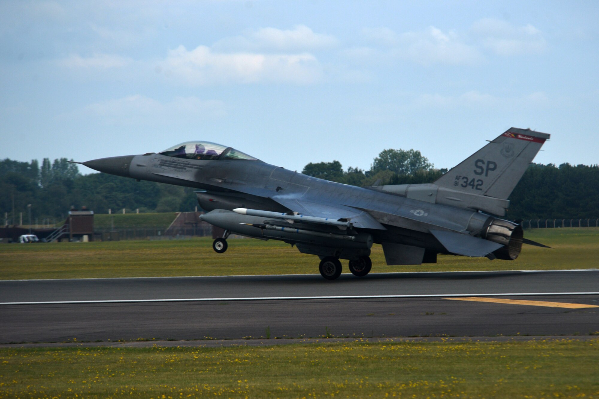 An F-16 Fighting Falcon from the 52nd Fighter Wing at Spangdahlem Air Base, Germany, lands at Royal Air Force Lakenheath, England, July 10. More than 260 Airmen and 18 F-16 Fighting Falcon aircraft from the 52nd FS will be participating in a flying training deployment here. (U.S. Air Force photo/Master Sgt. Eric Burks)