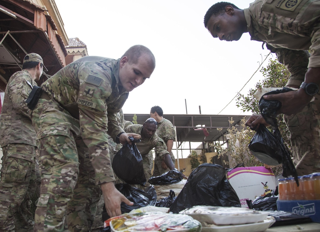 U.S. paratroopers prepare a meal to commemorate Independence Day at a Iraqi Federal Police patrol base in Mosul, Iraq, July 4, 2017. Army photo by Cpl. Rachel Diehm