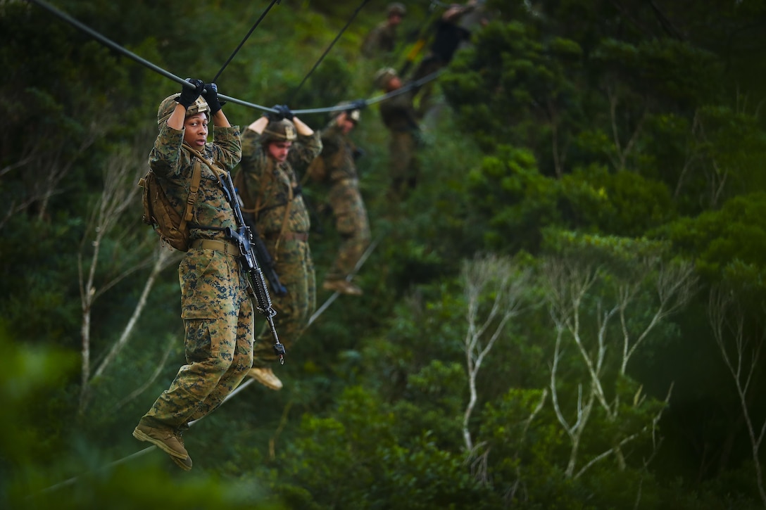 U.S Marines with Bravo Company, 1st Battalion, 3rd Marine Regiment, move along a rope obstacle during the endurance course, aboard Camp Gonsalves, Okinawa, Japan, July 7, 2017. The Jungle Warfare Training Center provides individual and unit level training to increase survivability and lethality while operating in a jungle environment. The Hawaii-based battalion is forward deployed to Okinawa, Japan as part of the Unit Deployment Program. 