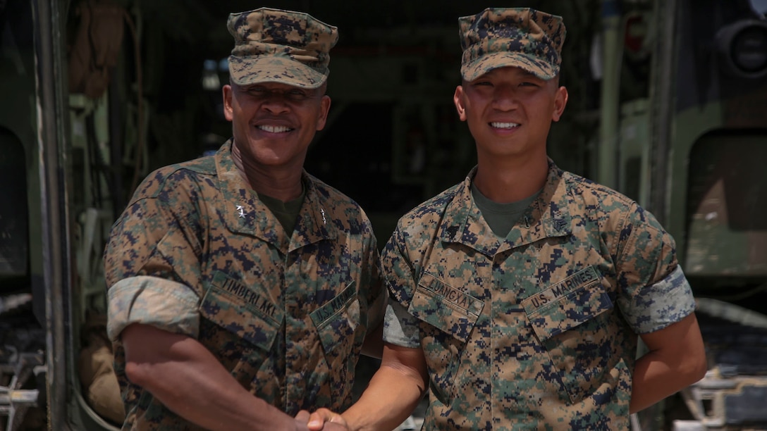 Sgt. Aenoi Luangxay, right, a squad leader with Combat Engineering Company, 3rd Combat Assault Battalion, 3rd Marine Division, III Marine Expeditionary Force, receives a challenge coin July 7, 2017, in Okinawa, Japan, from Maj. Gen. Craig Timberlake, the 3rd Marine Division commanding officer, for winning the outstanding squad leader award while participating in the 2nd annual Marine Corps Combat Engineer Sapper competition held in Camp Pendleton, California. Luangxay was one of four squad leaders to be in the running for the award.