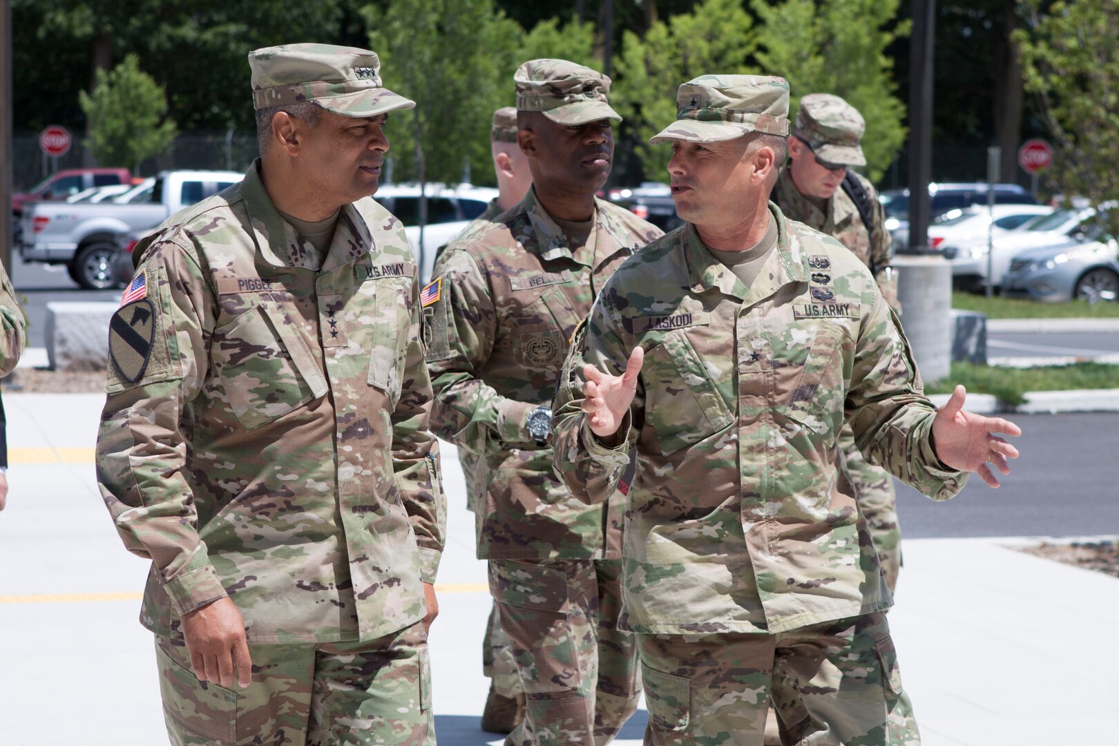 Army Lt. Gen.  Aundre F. Piggee (far left), deputy chief of staff for Army logistics (G-4) and members of his team join Brig. Gen. John Laskodi (right, gesturing), commander of DLA Distribution, at DLA Distribution headquarters June 27.