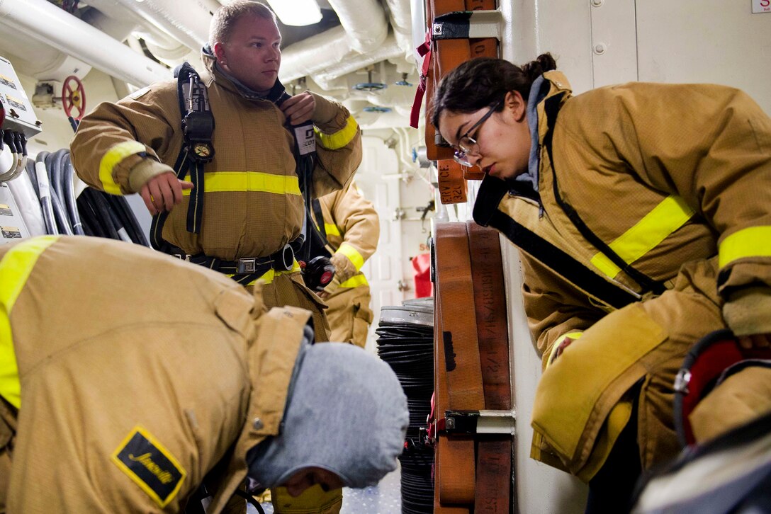 Sailors don firefighting equipment during a general quarters training evolution aboard the Arleigh Burke-class guided-missile destroyer USS Pinckney in the Pacific Ocean, July 2, 2017. Pinckney is currently deployed in the 7th Fleet area of operations. Navy photo by Petty Officer 2nd Class Craig Z. Rodarte
