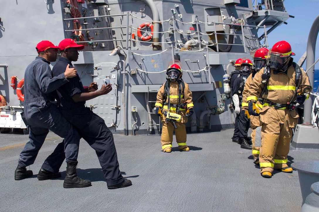 Sailors prepare to participate in firefighting training during a general quarters training evolution aboard the Arleigh Burke-class guided-missile destroyer USS Pinckney in the Pacific Ocean, July 2, 2017. Navy photo by Petty Officer 2nd Class Craig Z. Rodarte