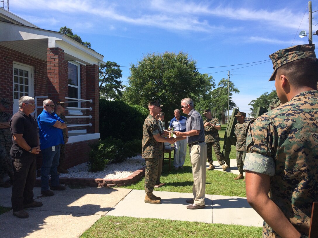 On June 29, 2017 Marine Corps Engineer School held a dedication ceremony for the TD-18 bulldozer. The process to request approval and funding to restore the TD-18 started in 2002 and was executed by the skilled technicians at 2d Maintenance Battalion. The ceremony marked the completion of thousands of man-hours of labor to restore and deliver the TD-18 to Courthouse Bay.  LtCol Greg Marchlinski presents Mr. Tom Roulund a plaque to show appreciation for his efforts throughout the restoration process. 