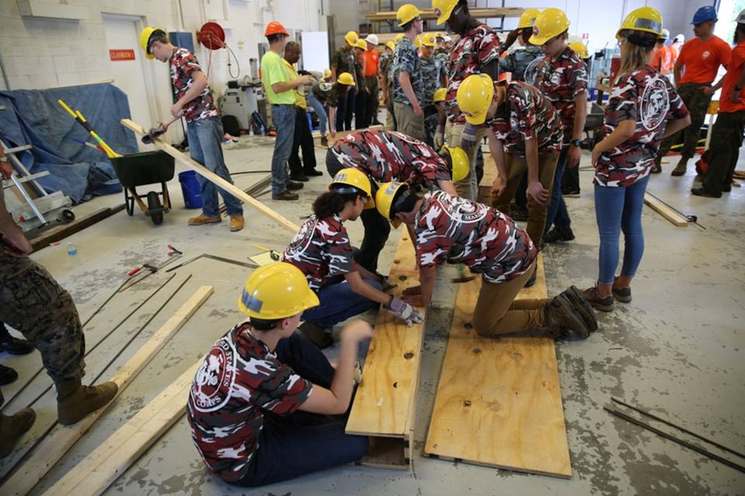 From June 17 to June 21, 2017 high school students from the Society of American Military Engineer (SAME) participate in engineer themed events at Courthouse Bay, Camp Lejeune, N.C. Students measure, cut, and assemble pieces of wood to construct a concrete beam form.