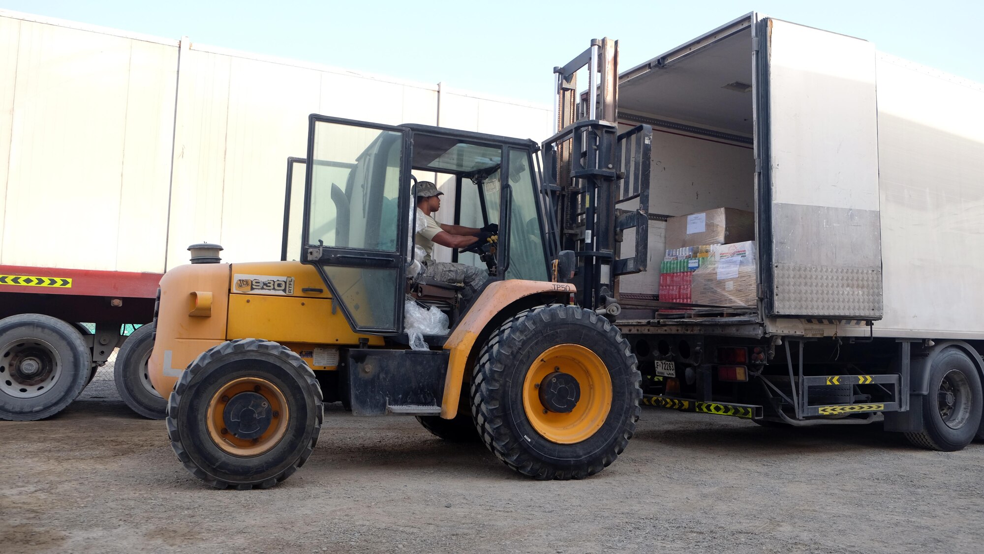 Staff Sgt. Roberto, 380th Force Support Squadron storeroom manager, unloads pallets of food July 6, 2017, at an undisclosed location in southwest Asia. All food for the compound is delivered to the Phantom West storeroom before it can be picked up by other teams. Roberto and Senior Airman Jaylin, 380 EFSS storeroom assistant, are also responsible for distributing all the water bottles on the compound; up to 80 locations. (U.S. Air Force photo by Senior Airman Preston Webb)