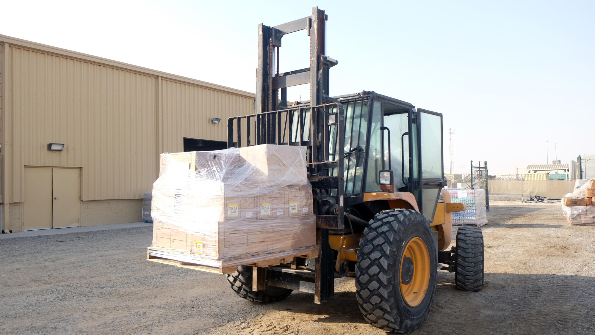 Staff Sgt. Roberto, 380th Force Support Squadron storeroom manager, unloads pallets of food July 6, 2017, at an undisclosed location in southwest Asia. The 380 EFSS unloads approximately $200,000 worth of food every week. Roberto and Senior Airman Jaylin, 380 EFSS storeroom assistant, are also responsible for water distribution for up to 80 locations on the compound. (U.S. Air Force photo by Senior Airman Preston Webb)