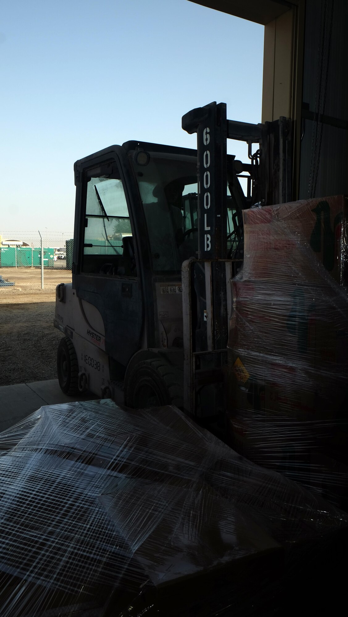 Senior Airman Jaylin, 380th Force Support Squadron storeroom assistant, unloads pallets of food July 6, 2017, at an undisclosed location in southwest Asia. To supply 380 AEW Airmen and Coalition partners, and therefore the mission, 380 EFSS orders approximately $200,000 in food each week. They also deliver pallets of water to up to 80 locations around the compound to keep Airmen hydrated. (U.S. Air Force photo by Senior Airman Preston Webb)
