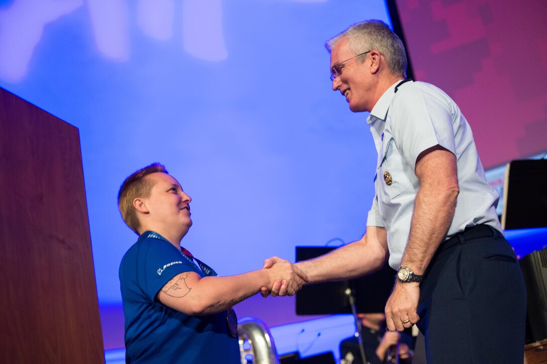 Air Force Gen. Paul J. Selva, vice chairman of the Joint Chiefs of Staff, congratulates Ret. Air Force Senior Airman Jamie Biviano for winning the Ultimate Champion Gold Medal during the closing ceremonies for the  2017 Department of Defense Warrior Games in Chicago, July 8, 2017. DoD photo by Army Sgt. James K. McCann