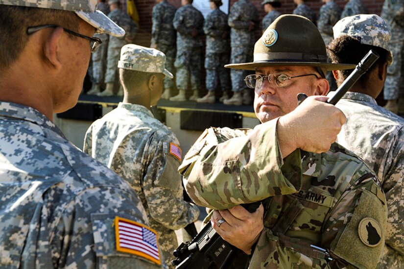 Sgt. 1st Class James Smith, a U.S. Army Reserve drill sergeant assigned to Task Force Wolf, provides instruction to a Reserve Officers’ Training Corps (ROTC) cadet during Cadet Summer Training (CST) at Fort Knox, Ky., June 7, 2017.  As a civilian, Sgt. 1st Class Smith delivers mail for the U.S. Postal Service. Qualified and experienced Soldiers are in high demand for numerous training and support positions as the Army Reserve takes on a greater role in America’s highly sophisticated, full-spectrum fighting force. (U.S. Army photo by Army Staff Sgt. Scott Griffin, U.S. Army Reserve Command-Public Affairs Office) (RELEASED)