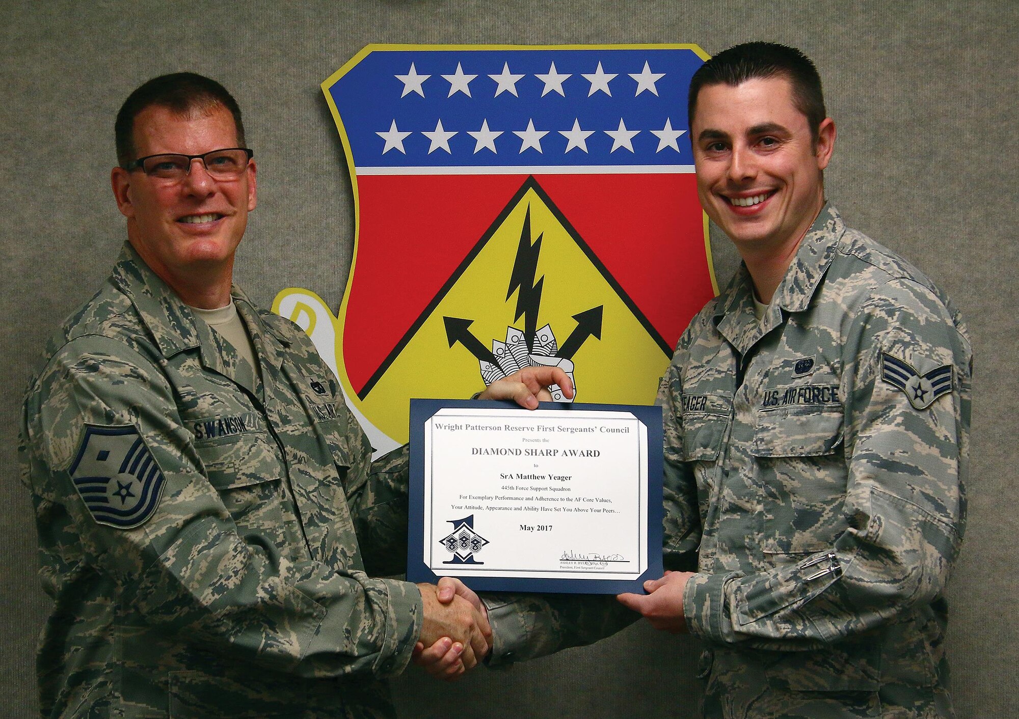 Master Sgt. Jay Swanson, 445th Force Support Squadron first sergeant, presents the May 2017 Diamond Sharp Award to Senior Airman Matthew Yeager, 445th FSS communications element client systems technician, June 3, 2017. The award is for exemplary performance, adherence to the Air Force Core Values, attitude, appearance and ability. (U.S. Air Force photo/Tech. Sgt. Patrick O’Reilly)