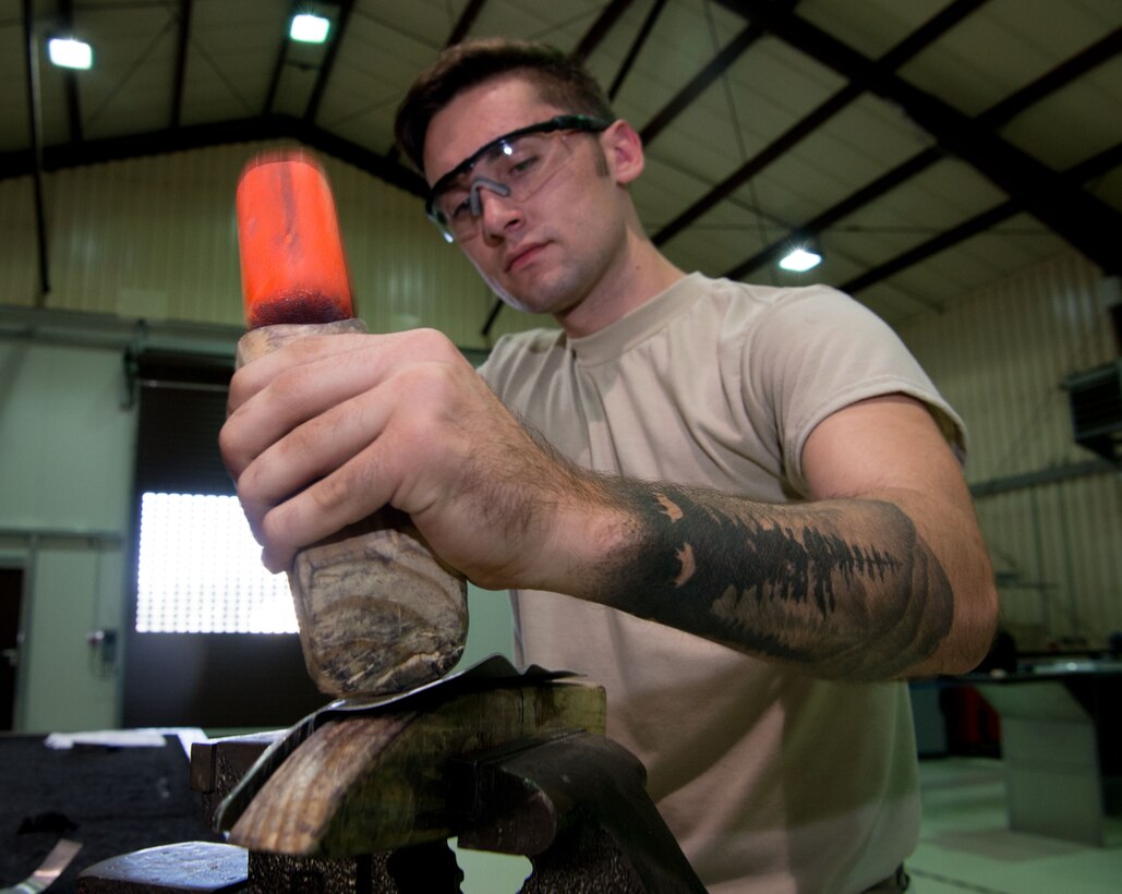 U.S. Air Force Airman 1st Class Luke Gibson, 86th Maintenance Squadron aircraft structural maintenance apprentice, shapes a piece of metal around the template for a C-130 inner flap rib on Ramstein Air Base, Germany, July 5, 2017.  The aircraft structural maintenance shop helps maintain the hull structure of aircraft on Ramstein by repairing or replicating damaged sheet metal parts. Manufacturing the parts in-house rather than ordering them saves the Air Force time and money. (U.S. Air Force photo by Senior Airman Elizabeth Baker)