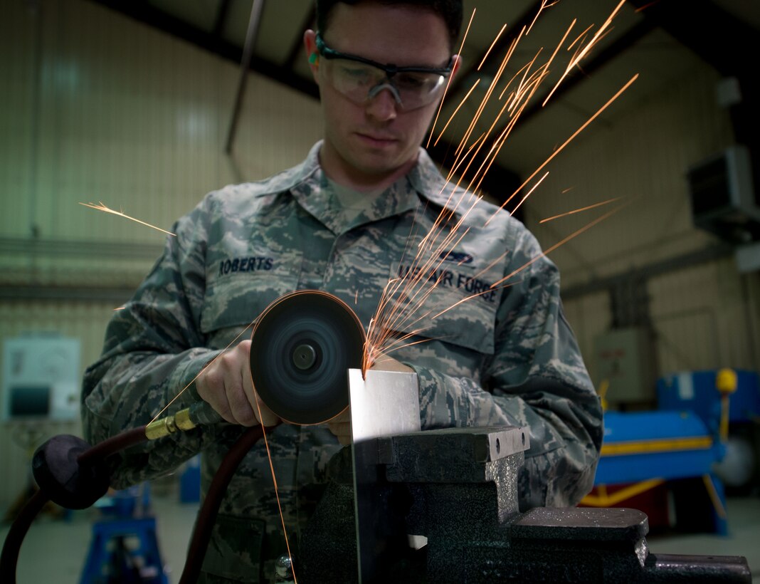 U.S. Air Force Senior Airman Houston Roberts, 86th Maintenance Squadron aircraft structural maintenance journeyman, uses a vice and cutoff wheel to cut through a piece of steel on Ramstein Air Base, Germany, July 5, 2017. When aircraft on Ramstein need new sheet metal parts, the aircraft structural maintenance shop uses a variety of cutting, crimping, and shaping tools to repair or manufacture those parts in a timely and cost-efficient manner. (U.S. Air Force photo by Senior Airman Elizabeth Baker)