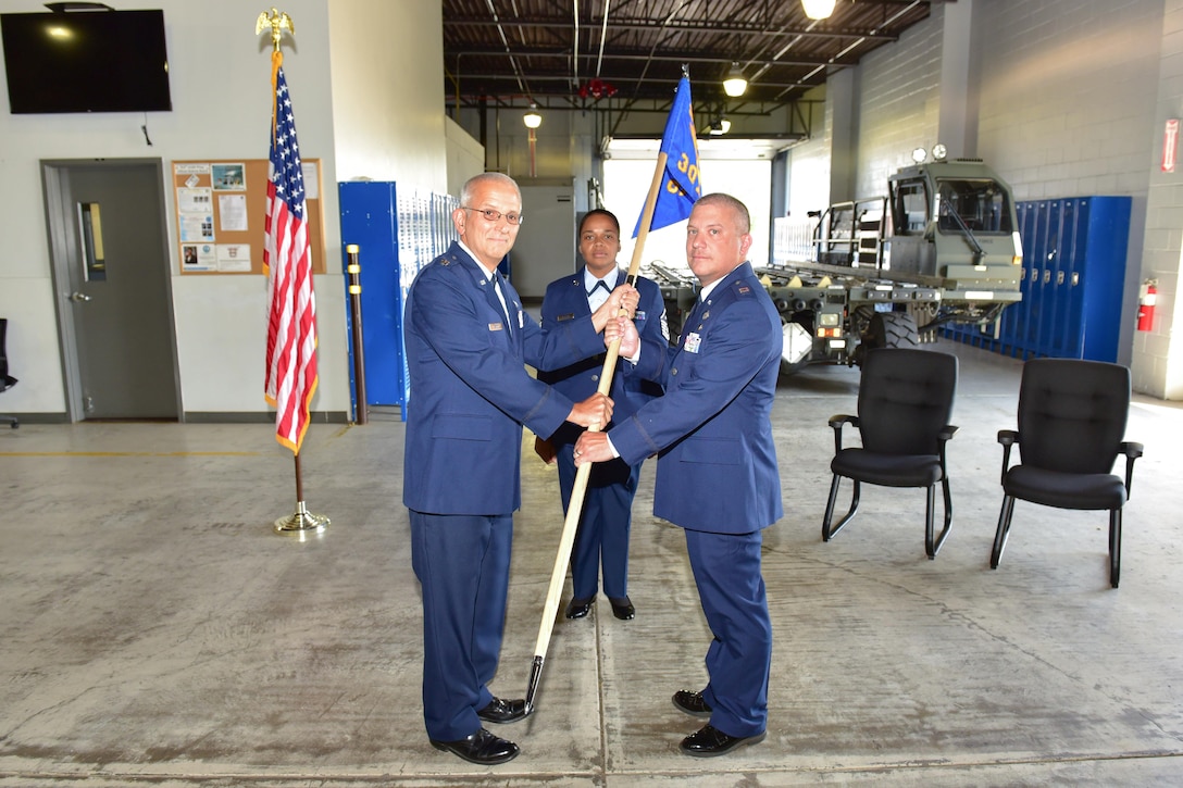 Lt. Col. Paul E. Cannon hands the Mission Support Group guidon to incoming 30th Aerial Port Squadron commander, Capt. Douglas B. Buffone, at an official change of command ceremony at the 914th Air Refueling Wing, July 8, 2017, NIAGARA FALLS, N.Y. Buffone has been interim commander since January of this year. (U.S. Air Force photograph by Staff Sgt. Richard Mekkri)