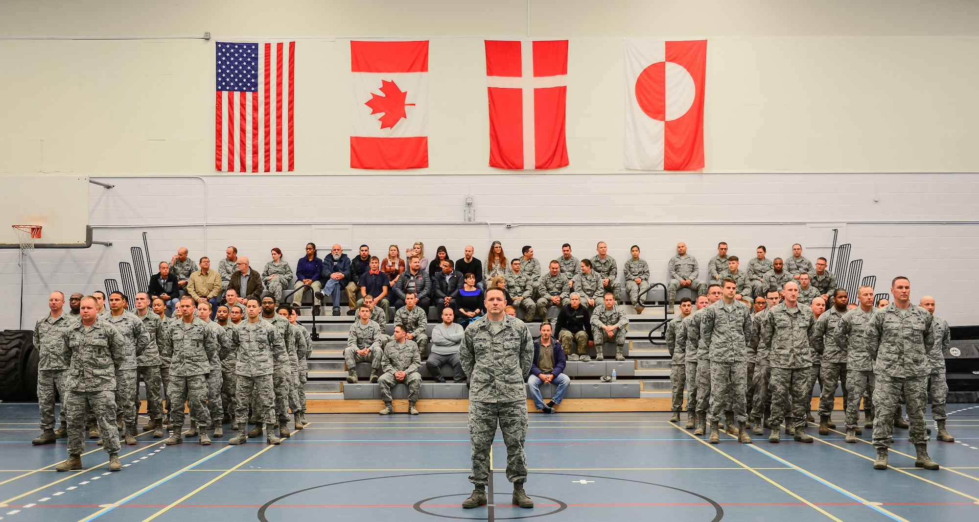 Airmen from the 821st Air Base Group stand in formation and attend the 821st ABG change of command, June 29, 2017, at Thule Air Base, Greenland. The 821st ABG operates and maintains the air base in support of missile warning, space surveillance, and satellite command and control operations and missions. (U.S. Air Force photo by Capt. Md Hussain)