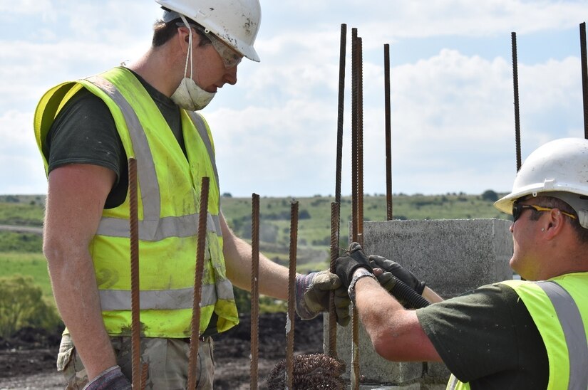 Cpl. Matt Williams of the 225th Field Engineers, U.K. Royal Monmouthshire Royal Engineers (Militia), ties rebar while Sapper Mulligan holds it steady. The rebar is internal wall support for a Light Demolition Range being built as part of Operation Resolute Castle 2017 at the Joint National Training Center, Cincu, Romania. Resolute Castle is an exercise strengthening the NATO alliance and enhancing its capacity for joint training and response to threats within the region.