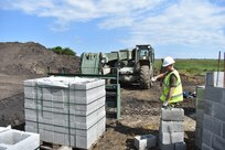 A Soldier of the 225th Field Engineers, U.K. Royal Monmouthshire Royal Engineers (Militia), ground guides Staff Sgt. Benjamin Sykora of the 926th Engineer Brigade, United States Army Reservse, as he moves construction materials. The concrete blocks are for a Light Demolition Range. The construction project is a part of Operation Resolute Castle 2017 at the Joint National Training Center, Cincu, Romania. Resolute Castle is an exercise strengthening the NATO alliance and enhancing its capacity for joint training and response to threats within the region.