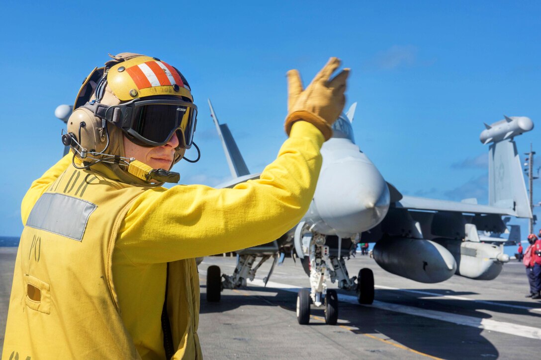 Navy Petty Officer 1st Class Nicholas Wareham directs an EA-18G Growler on the flight deck aboard the aircraft carrier USS Ronald Reagan in the Pacific Ocean, July 4, 2017. Wareham is an aviation boatswain's mate (handling). The Ronald Reagan is on patrol in the U.S. 7th Fleet area of responsibility to support security and stability in the Indo-Asia-Pacific region. Navy photo by Petty Officer 2nd Class Kenneth Abbate