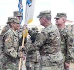 Col. Ingrid Parker (left) accepts the colors of the 470th Military Intelligence Brigade from Maj. Gen. Christopher Ballard, U.S. Army Intelligence and Security Command commanding general, during a change of command ceremony held on the MacArthur Parade Field at Joint Base San Antonio-Fort Sam Houston July 7. Parker takes over for Col. James “Jamey” Royse (right), who was the brigade’s commander for two years. Royse is leaving the 470th MIB to become director of intelligence for U.S. Army Central at Shaw Air Force Base, S.C.