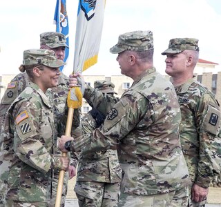 Col. Ingrid Parker (left) accepts the colors of the 470th Military Intelligence Brigade from Maj. Gen. Christopher Ballard, U.S. Army Intelligence and Security Command commanding general, during a change of command ceremony held on the MacArthur Parade Field at Joint Base San Antonio-Fort Sam Houston July 7. Parker takes over for Col. James “Jamey” Royse (right), who was the brigade’s commander for two years. Royse is leaving the 470th MIB to become director of intelligence for U.S. Army Central at Shaw Air Force Base, S.C.