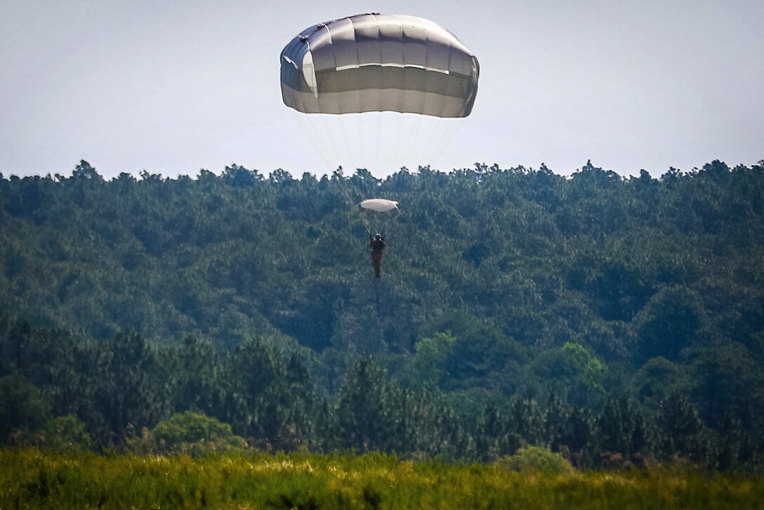 A paratrooper braces for a parachute landing during airborne operations over Sicily drop zone at Fort Bragg, N.C., July 6, 2017. Army photo by Sgt. Steven Galimore 