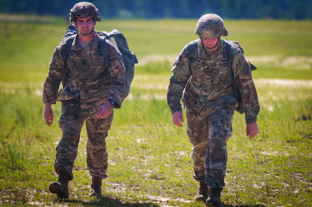 Army Command Sgt. Maj. Erick Ochs, left, and Lt. Col. Rhett D. Thompson walk to the rally point after jumping from a CH-47 Chinook helicopter during airborne operations at Sicily drop zone at Fort Bragg, N.C., July 6, 2017. Ochs is the senior enlisted noncommissioned officer assigned to the 82nd Airborne Division’s 2nd Battalion, 505th Parachute Regiment, 3rd Brigade Combat Team. Army photo by Sgt. Steven Galimore